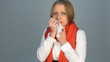 sick young woman in red scarf coughing and sneezing