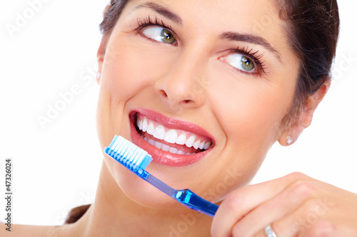 Photo: Beautiful woman smile with a toothbrush. Beautiful woman smile with a toothbrush.
