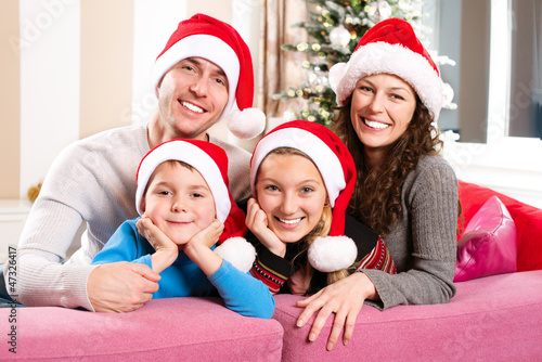 Photo: Christmas Family with Kids. Happy Smiling Parents and Children Christmas Family with Kids. Happy Smiling Parents and Children