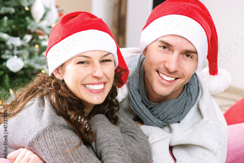 Photo: Christmas Couple wearing Santa's Hat Christmas Couple wearing Santa's Hat