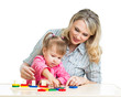 Foto: mother and her child playing with colorful puzzle toy mother and her child playing with colorful puzzle toy