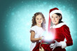 Little girl with christmas gifts and santa