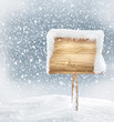 wooden signboard in snow