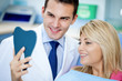 Dentist and satisfied patient with white teeth