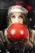 Photo: Young Christmas Girl Blowing Up Party Balloon Young Christmas Girl Blowing Up Party Balloon