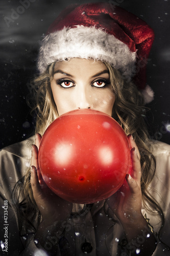 Photo: Young Christmas Girl Blowing Up Party Balloon Young Christmas Girl Blowing Up Party Balloon