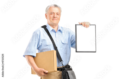 Photo: A delivery person holding a clipboard and box A delivery person holding a clipboard and box