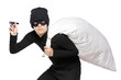A robber with a bag on his back and flashlight