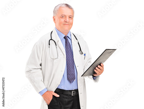 Photo: A mature doctor holding a clipboard A mature doctor holding a clipboard