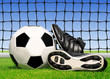 soccer ball and shoes in grass