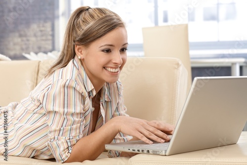 Photo: Attractive woman using laptop at home Attractive woman using laptop at home
