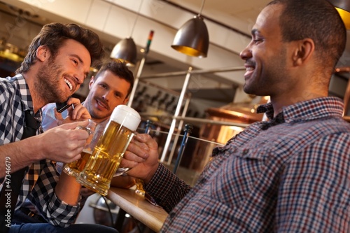 Photo: Friends drinking in pub Friends drinking in pub