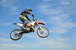 High flight by motorcycle racer motocross against the blue sky