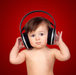 Adorable baby girl with big headphones