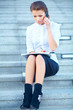 Young businesswoman sitting on stairway