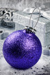 Purple Christmas bauble on silver background