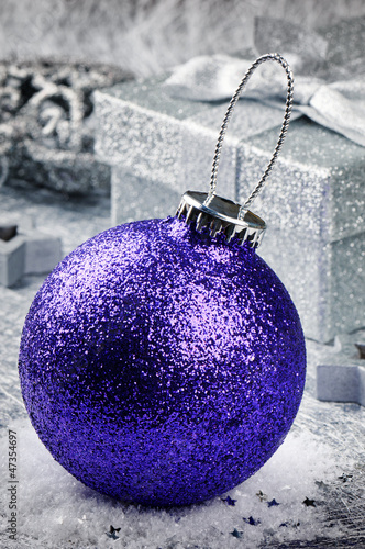 Photo: Purple Christmas bauble on silver background Purple Christmas bauble on silver background