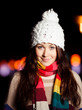 Portrait of young woman in city at night