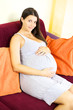 Happy smiling beautiful pregnant woman at home