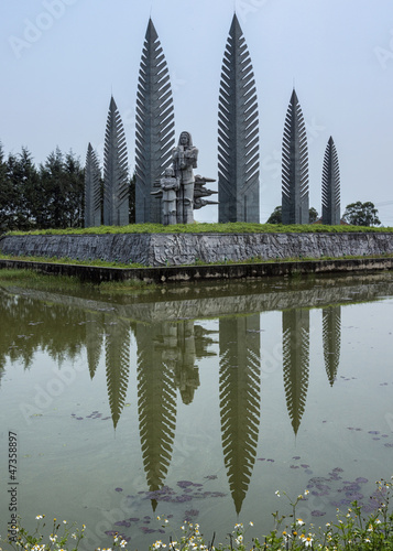 Photo: Vietnam - DMZ: War memorial of sad woman with child in reflectin Vietnam - DMZ: War memorial of sad woman with child in reflectin