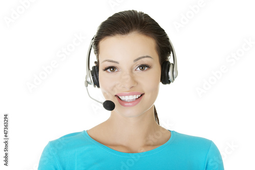 Photo: Beautiful young call-center assistant smiling Beautiful young call-center assistant smiling