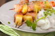 salmon skewers with pineapple, rice noodles and mango salad