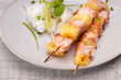 salmon skewers with pineapple, rice noodles and mango salad