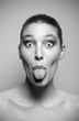 Photo: Young woman pokes out her tongue Young woman pokes out her tongue