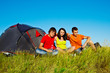 Teenagers beside a tent