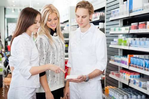 Photo: Pharmacist Assisting Female Shopper Pharmacist Assisting Female Shopper