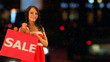 Woman with sale shopping bag outdoor.