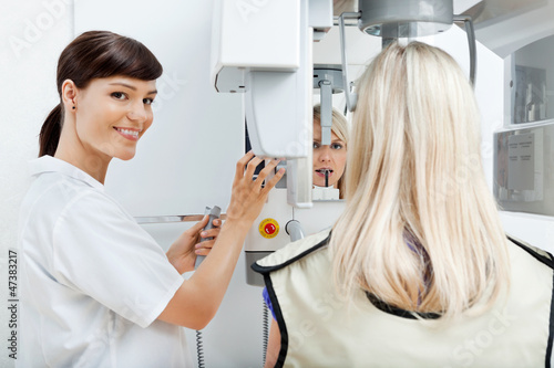 Photo: Female Dentist Getting Her Patient's Teeth X-Rayed Female Dentist Getting Her Patient's Teeth X-Rayed