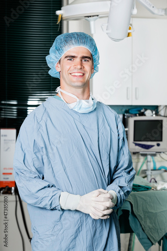 Photo: Cheerful Male Surgeon With Hands Clasped Cheerful Male Surgeon With Hands Clasped