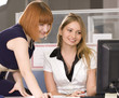 Smiling girl looking at a computer monitor