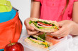 Child removing wholemeal sandwich out of lunchbox