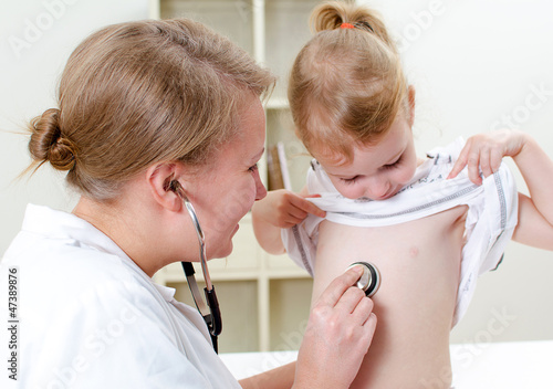 Photo: Female doctor examining little girl with stethoscope Female doctor examining little girl with stethoscope