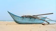 Fishing boat by the shore at Bentota Beach, Sri Lanka