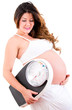 Pregnant woman holding a scale