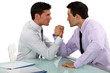Businessmen arm wrestling