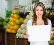 Woman with an open sign at her business
