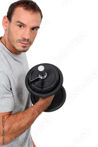 Photo: man training with a dumbbell man training with a dumbbell