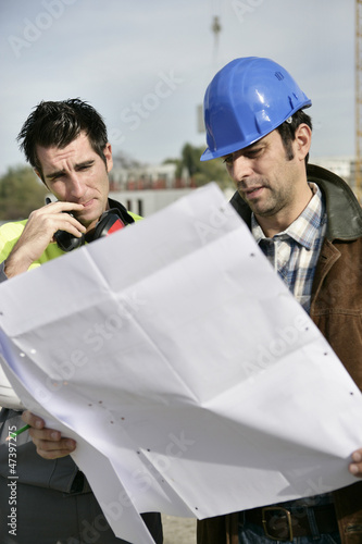 Photo: Foreman and colleague checking over plans Foreman and colleague checking over plans