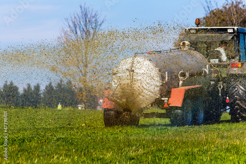 Photo: Traktor düngt mit Gülle ein Feld Traktor düngt mit Gülle ein Feld