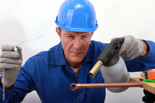 Photo: craftsman soldering a copper pipe craftsman soldering a copper pipe
