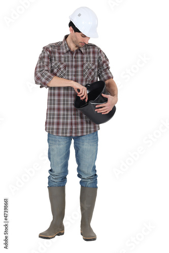 Photo: Man mixing cement in bucket Man mixing cement in bucket