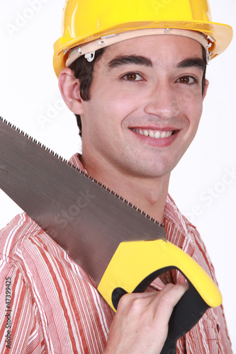 Photo: Young carpenter holding hand-saw Young carpenter holding hand-saw