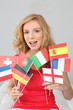Fair haired woman with a variety of European flags
