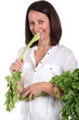 Woman eating a branch of celery