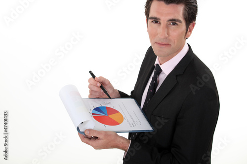Photo: Man holding pie-chart and pen Man holding pie-chart and pen
