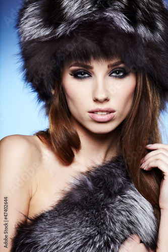 Photo: Fur Fashion. Beautiful Girl in Fur Hat. Winter Woman Portrait Fur Fashion. Beautiful Girl in Fur Hat. Winter Woman Portrait